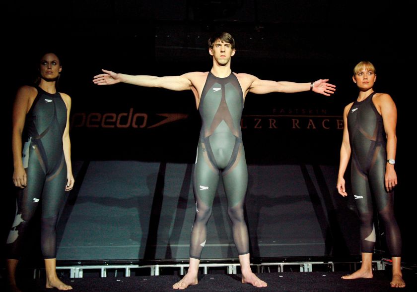 American Olympic medallists Amanda Beard, left, Natalie Coughlin, right, and Michael Phelps pose with in new, high technology Speedo LZR Racer swimsuits they will wear during the Beijing Summer Olympics during a news conference introducing the suits in New York, Tuesday, Feb. 12, 2008. Associated Press/Alamy Stock Photo