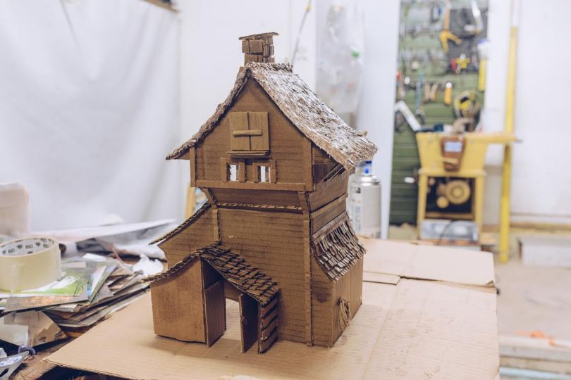 Miniature cardboard models that are photographed to look like the real